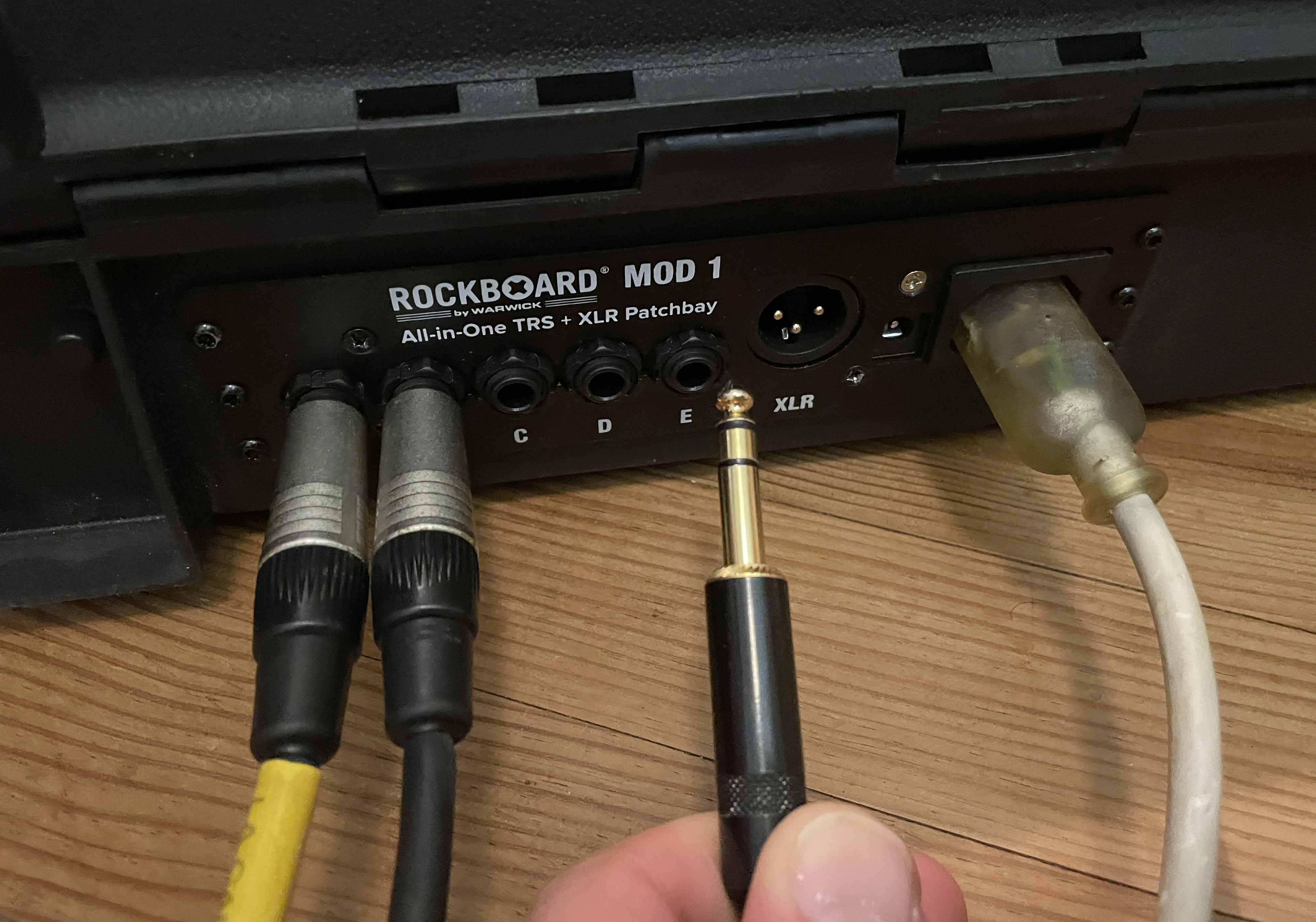 Back view of the patching bay with DC in and various TRS cables