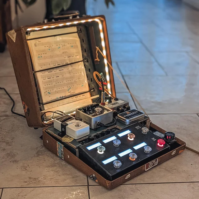 A pedalboard made with a typewriter case